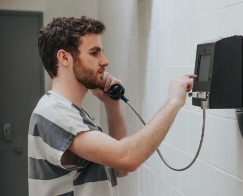 Man talking on phone in jail
